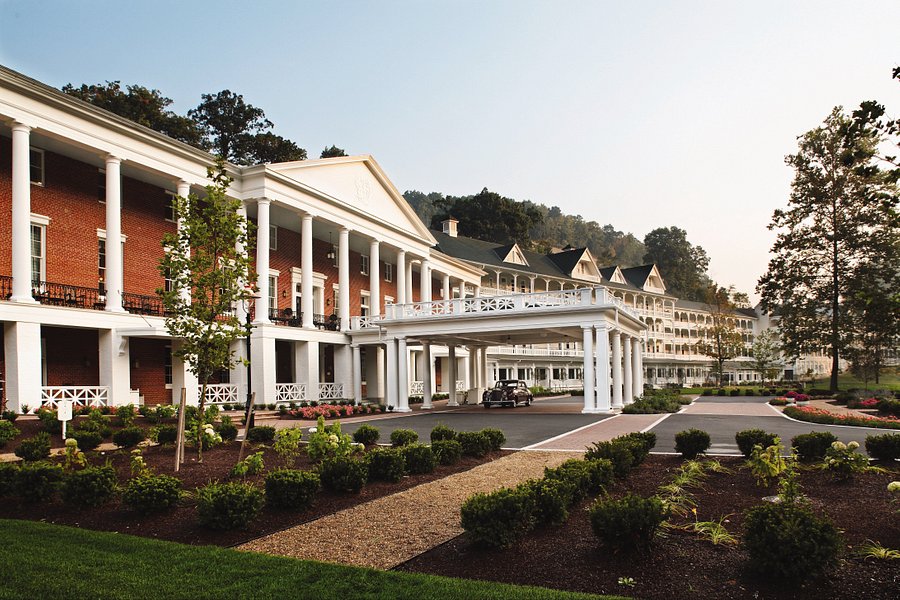 Exterior of resort in summer with white columns and brick