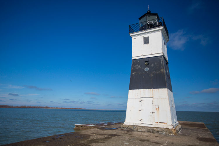 lighthouse post by lake