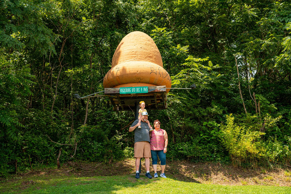 Family standing in front of Space Acron