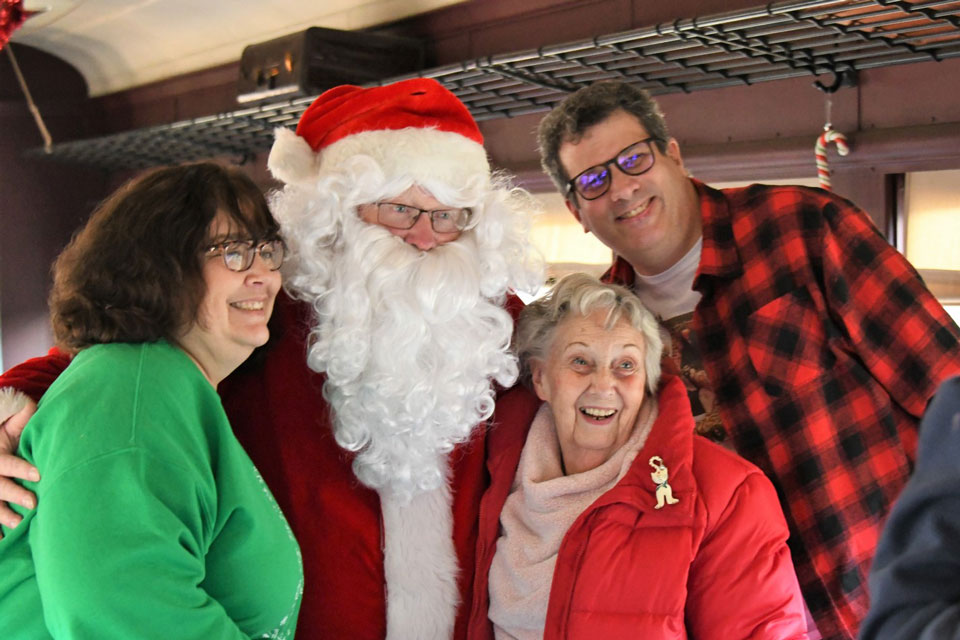 family posing for photo with santa