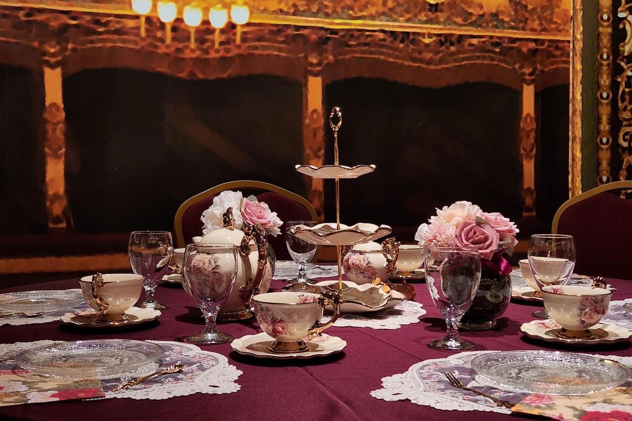 tea cups on table with red cover