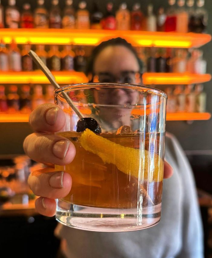 bar tender holding drink in hand