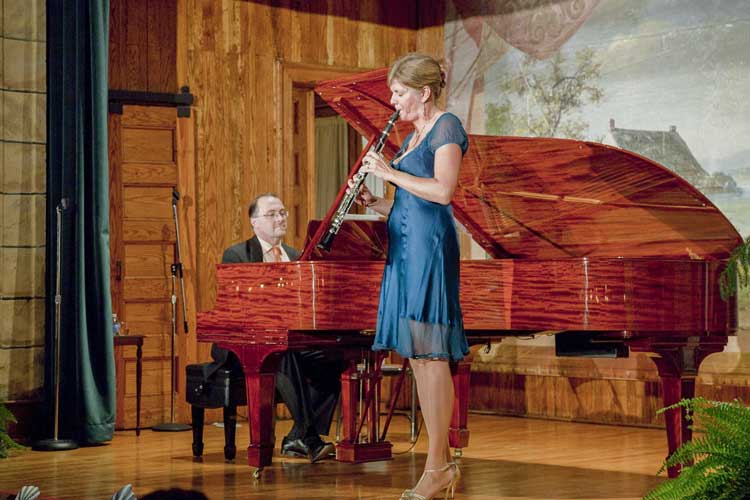 A person playing a piano another person playing saxophone