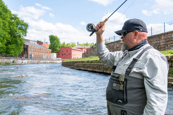 A Person holding a fishing rod in hand