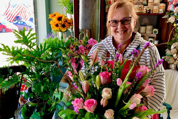 a lady holding a flower bouquet