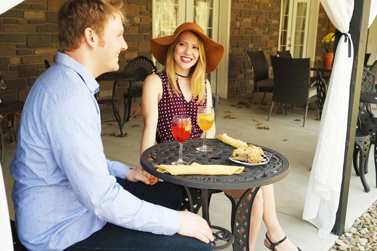 couple sitting on proch enjoying wine