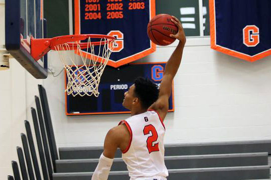 a person throwing ball into basket