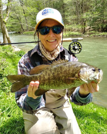 Women holding a Fish with both hands 