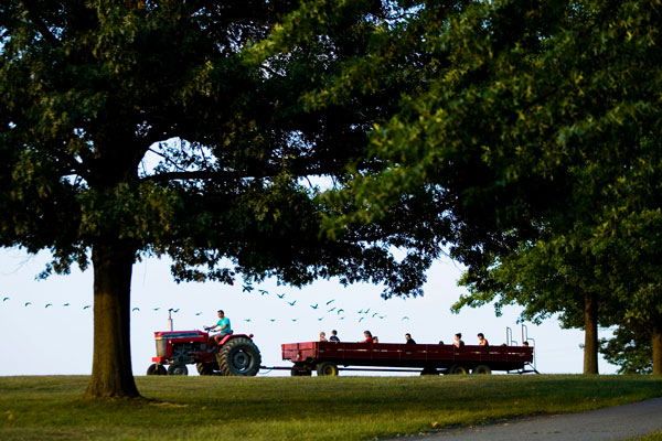 people riding Hay ride on farm