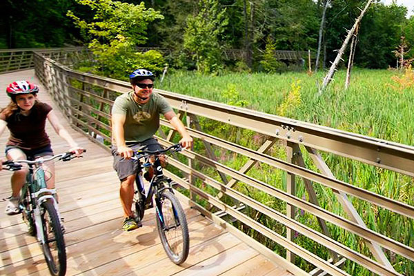 couple biking along trail