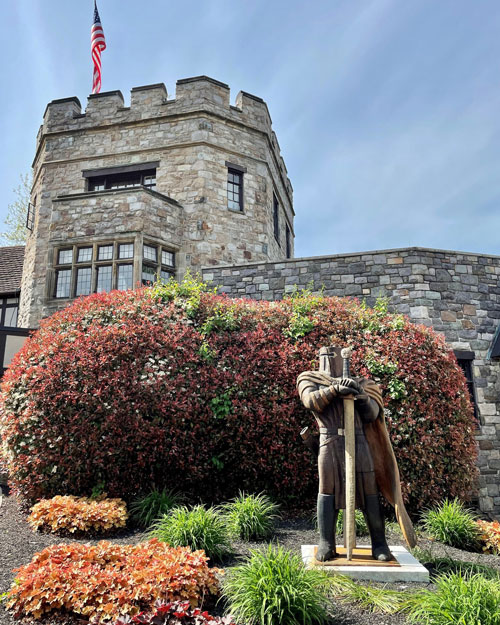 a knight statue in front yard of Castle