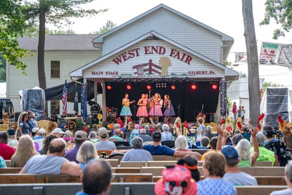 group performing at main stage with audience around