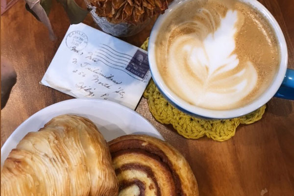 cinnamon bun with coffee on table