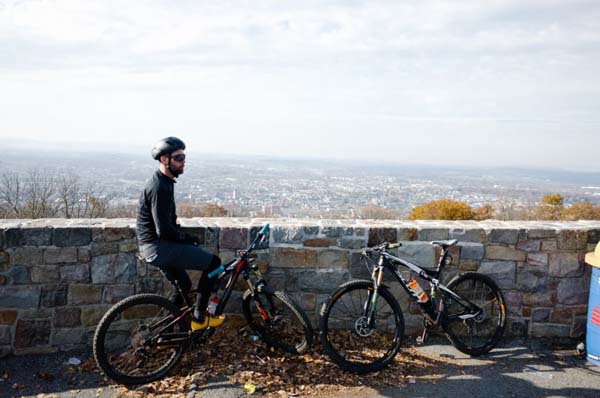 guy with bike gear sitting on his bike at overlook