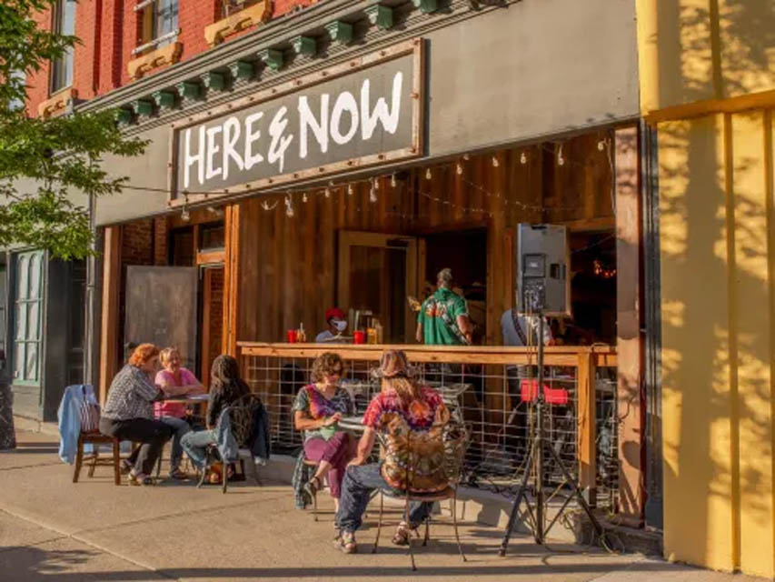 people sitting outside brewery