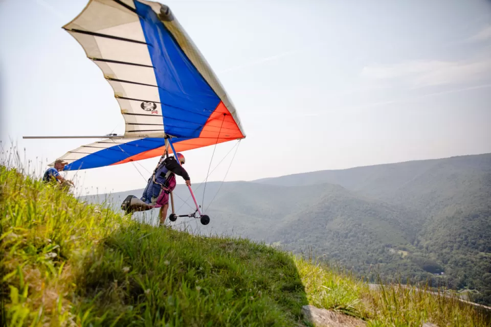 hang glide enthusiast taking off from cliff