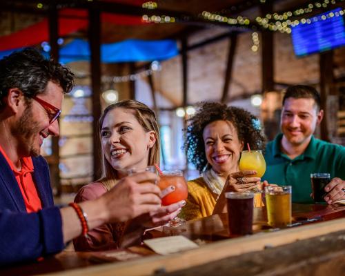 A photo of friends drinking beer, sitting at the bar at Battlefield Brew Works and Spirits