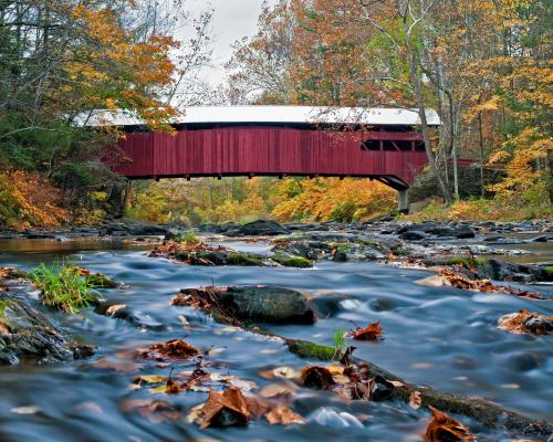 covered bridge with picturesque river underneath