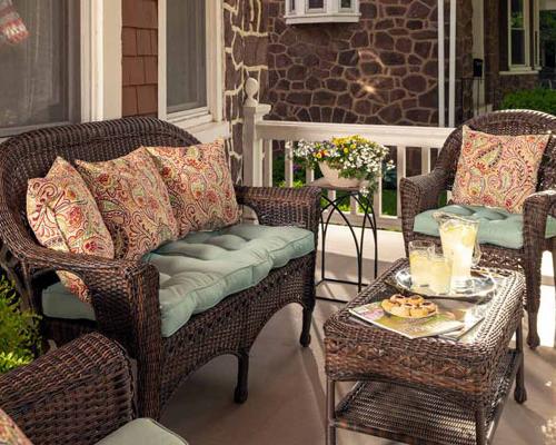 Three Daughters Inn common area front porch chairs to site and tea on table