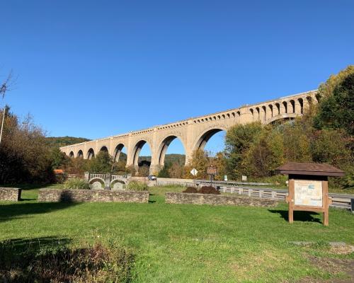 stone bridge over a grassy area