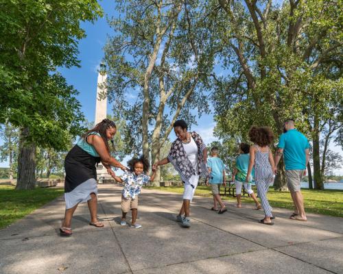 Family and kids walking around lighthouse