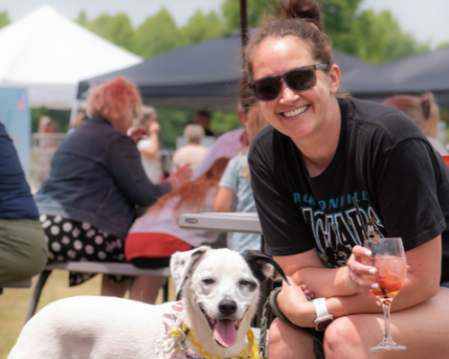 a women posing with a pup