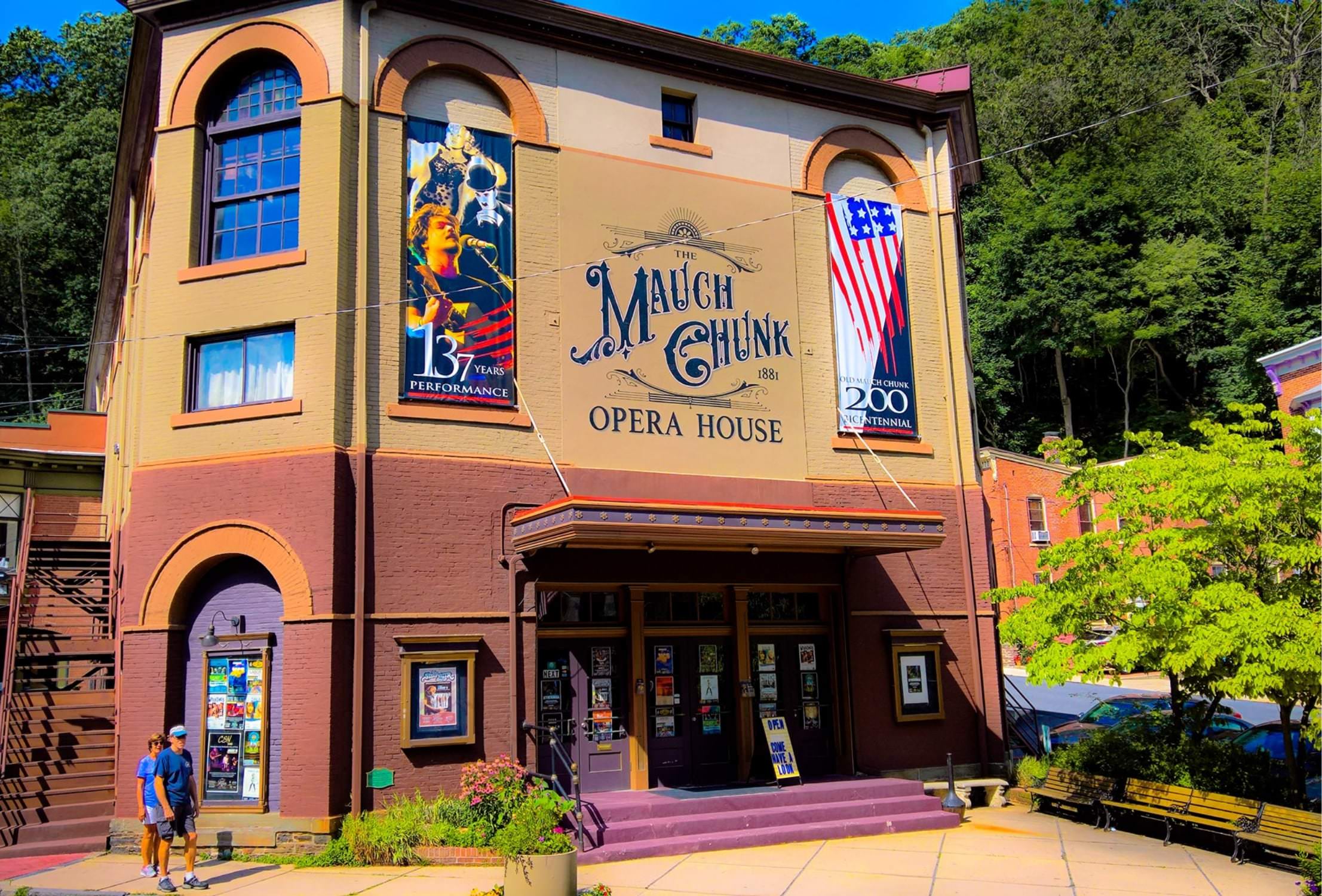 Tan and red building exterior with a sign that reads 'Mauch Chunk Opera House'